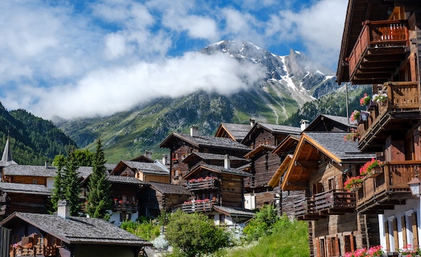 Traditional Swiss chalet with mountain backdrop
